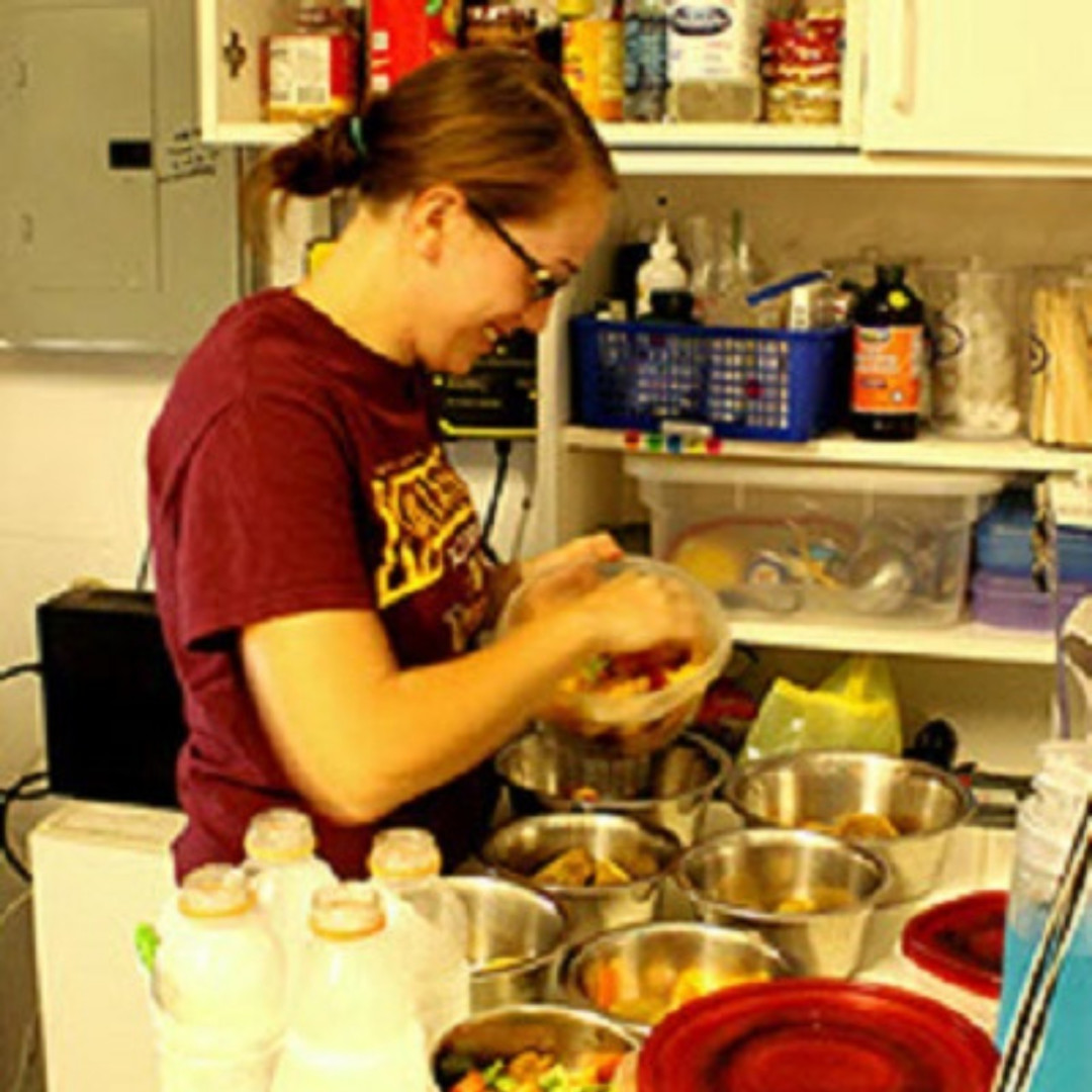 An LCF intern preparing food for distribution and becoming familiar with the nutritional needs of the lemurs at the reserve.