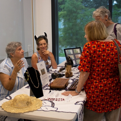 Volunteers talk with guests at the Madagascar table.