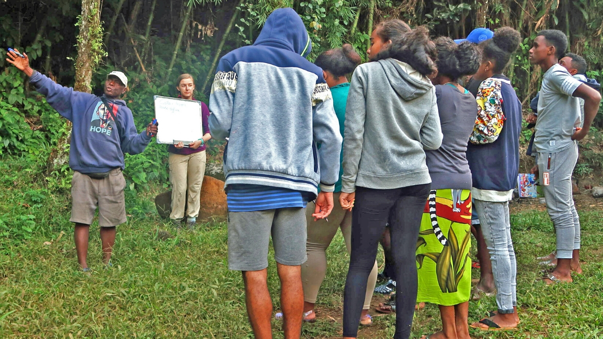 Malagasy students learning about the significance of the rainforest and its wildlife.